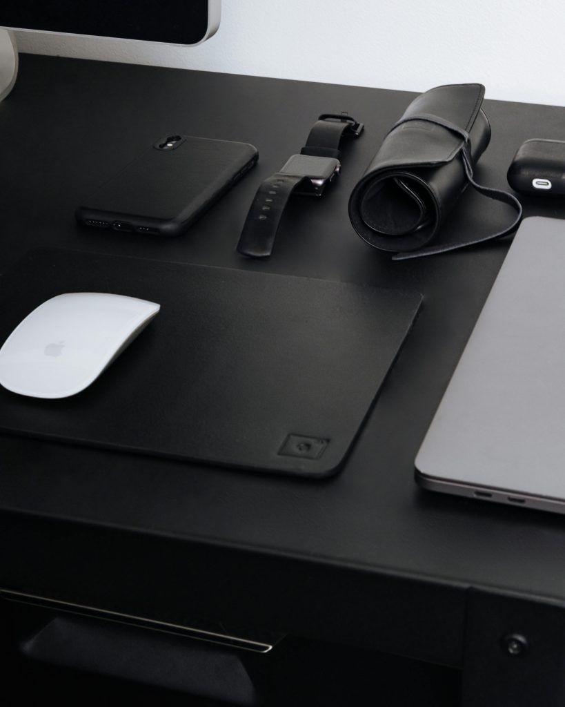 Laptop and mobile phone repair services on a work table – expert fixes for screens, batteries, and hardware.